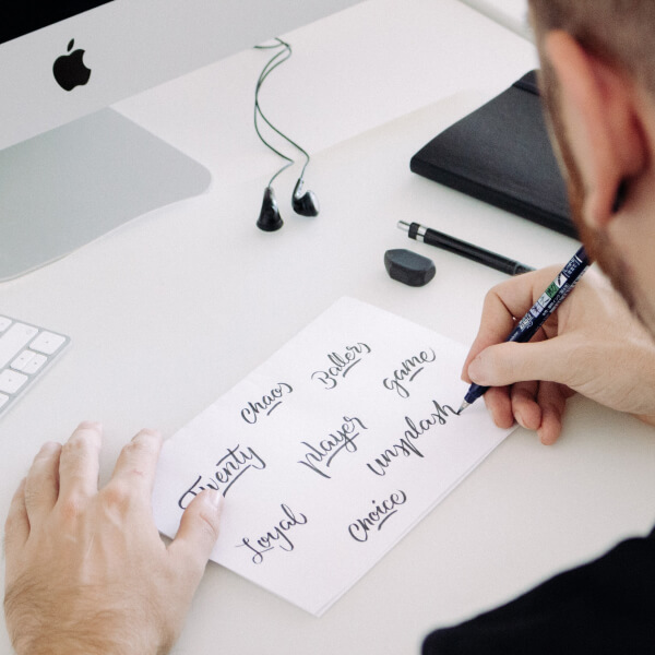 Man writing on a piece of paper image used in an article on freelance SEO copywriter service